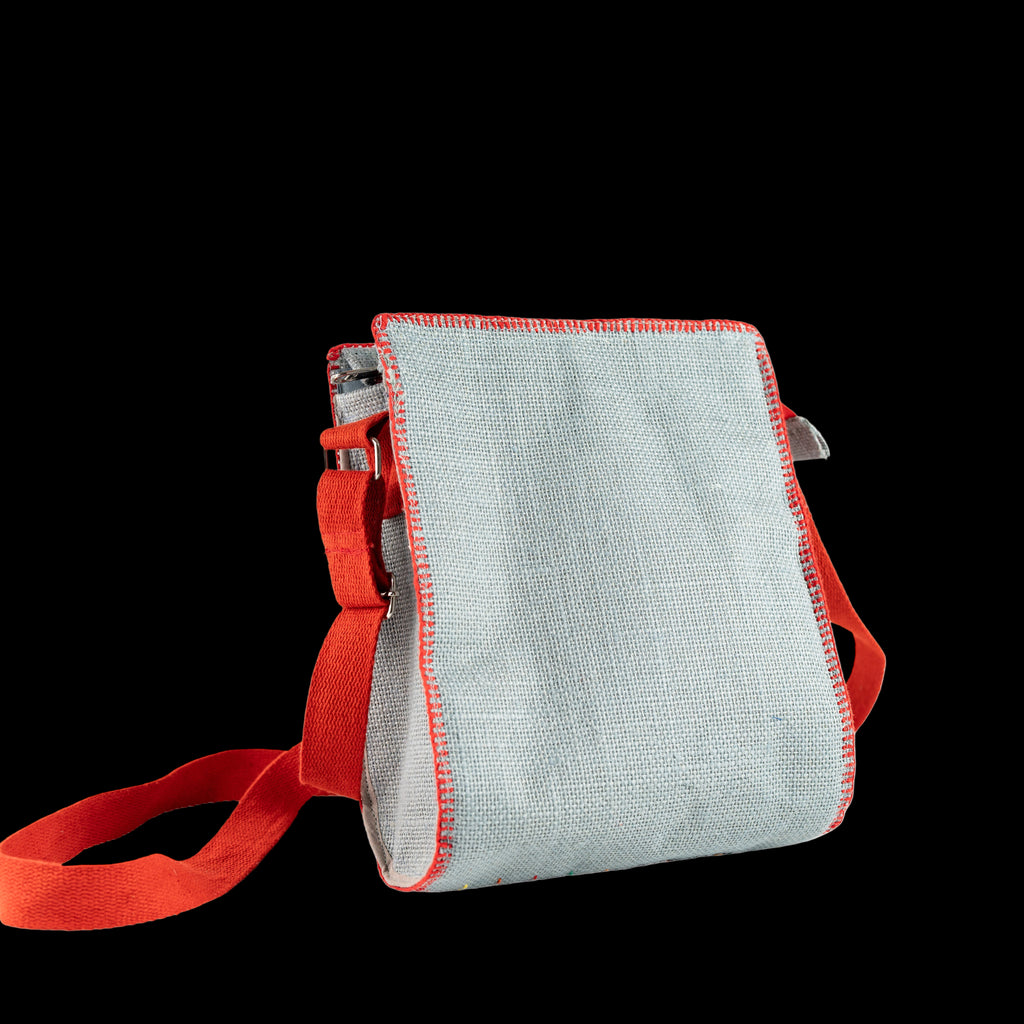 Small bag with red strap and trim on a white background